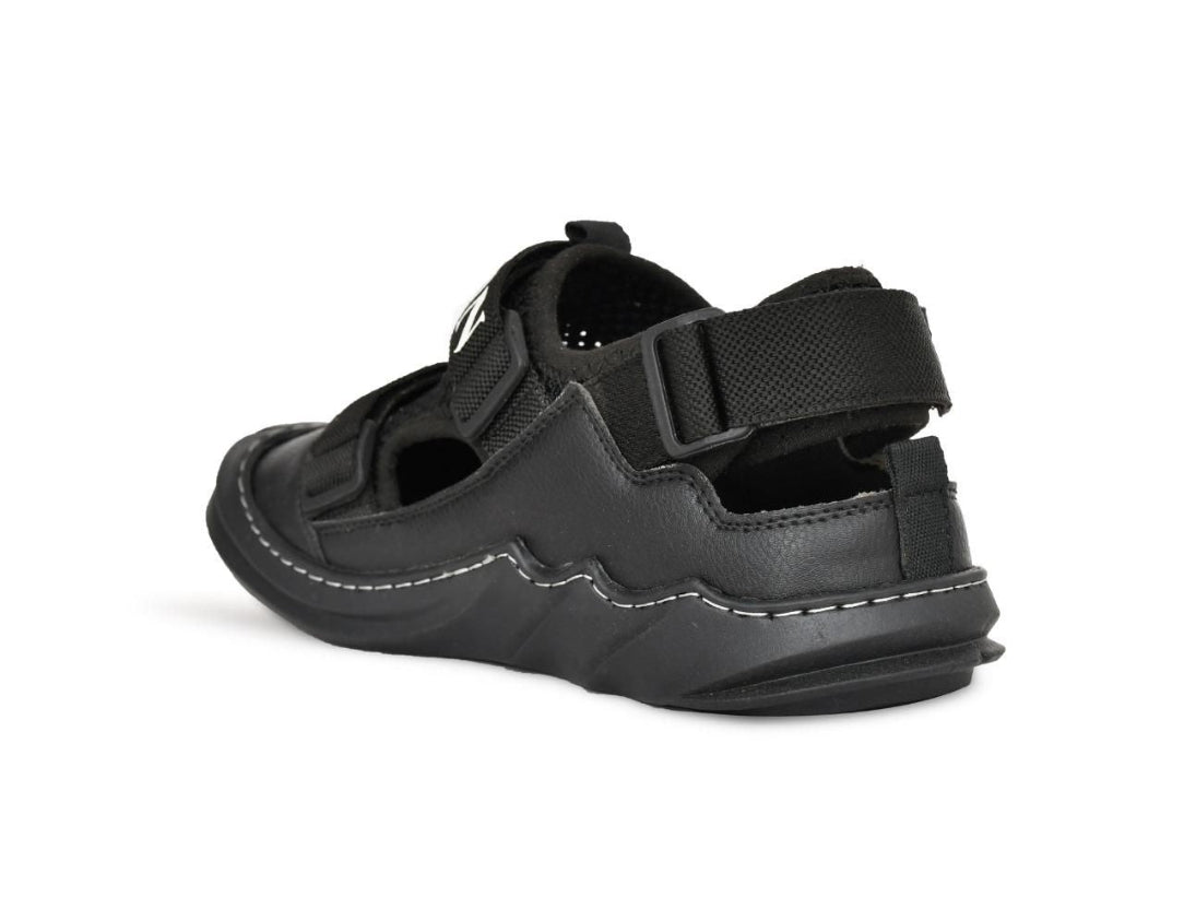 Black sandal with velcro straps on a white background