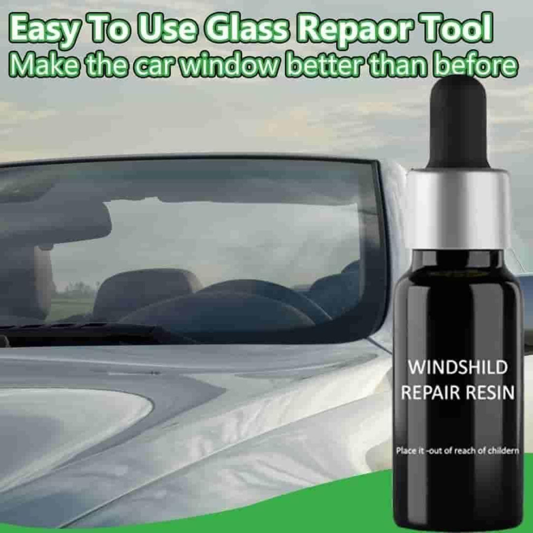 Bottle of windshield repair resin with a car in the background