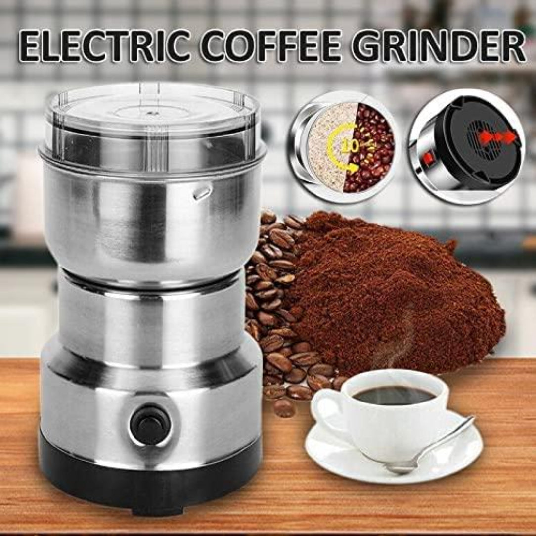 Electric coffee grinder with coffee beans, ground coffee, and a cup of coffee on a wooden surface.