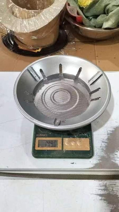 Metallic stove top on a digital scale with a wooden surface in the background