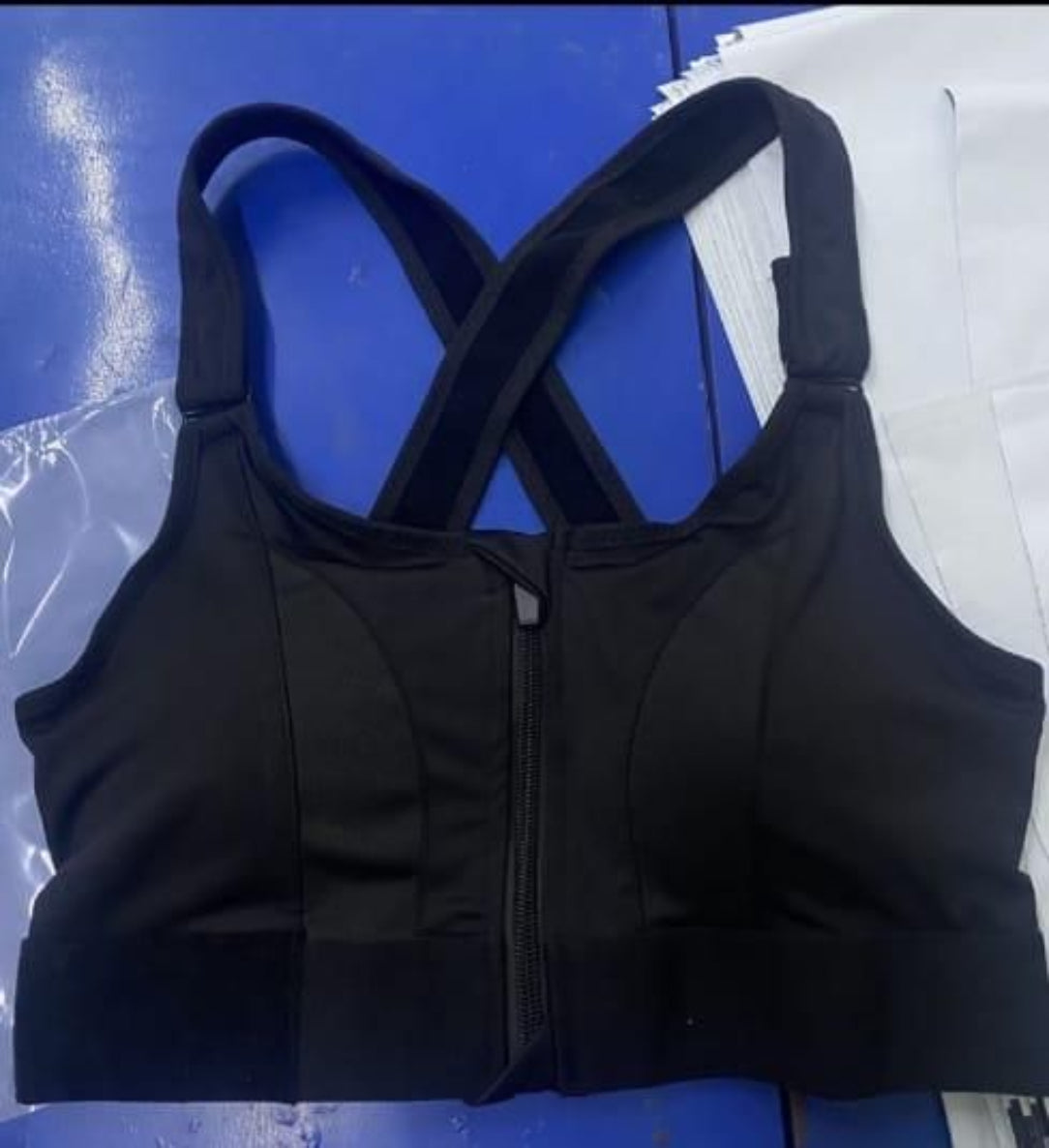 Black sports bra on a blue and white surface