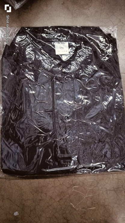 Black jacket in clear plastic wrap on a brown surface