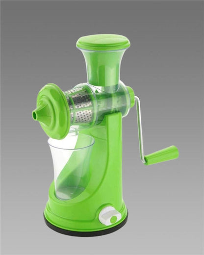 A green manual hand juicer with a steel handle, designed for extracting juice from fruits, placed against a neutral background.
