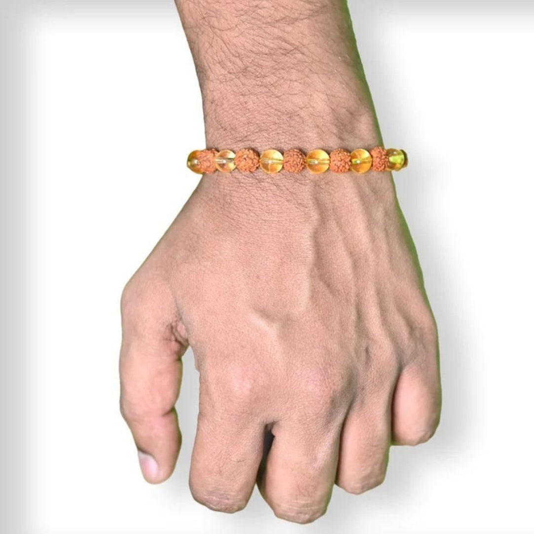 A person's hand wearing a Rudraksha Citrine Crystal Bracelet with a solid pattern and 8 mm beads.
