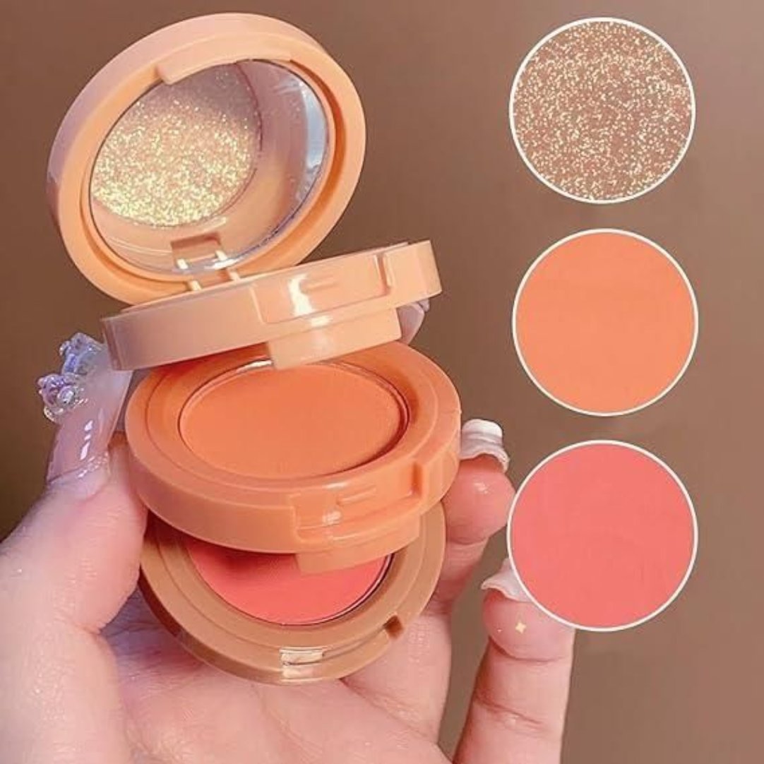 A compact palette with a face blusher and highlighter, shown open with the blush on one side and the highlighter on the other, held in a person's hand.