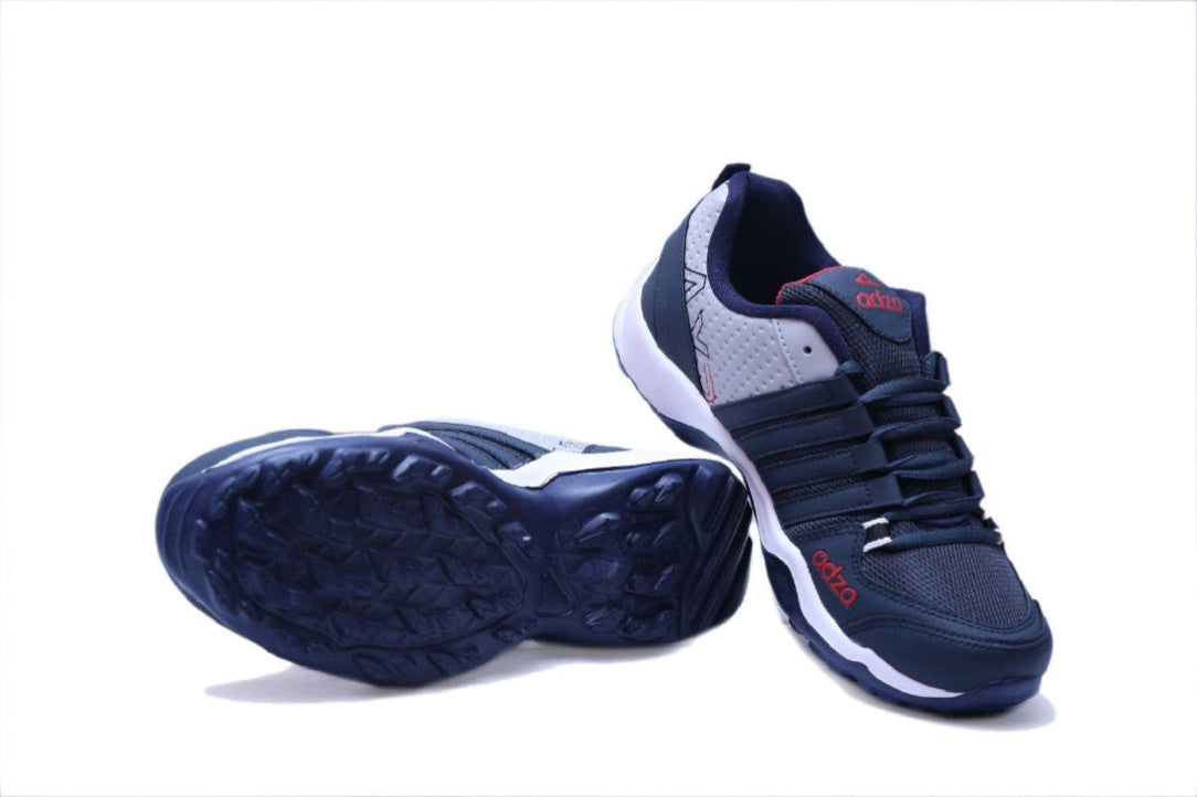 Navy blue athletic shoes with white soles on a white background