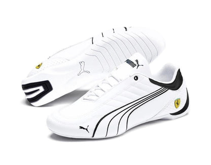 White sneakers with black accents and Puma logo on a white background