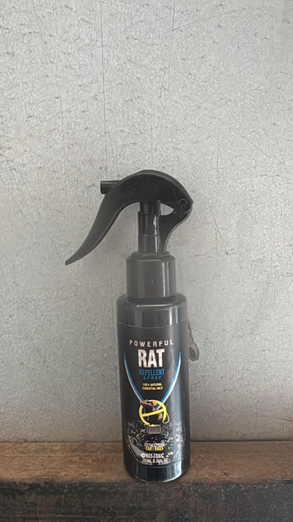 Black spray bottle labeled 'Powerful Rat' on a textured surface