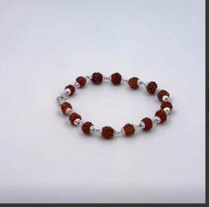 Bracelet with brown and silver beads on a light gray background
