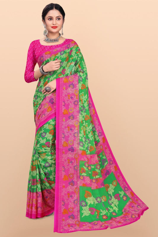 A woman showcasing a Georgette saree in a floral design with green and pink colors, along with a pink blouse piece.
