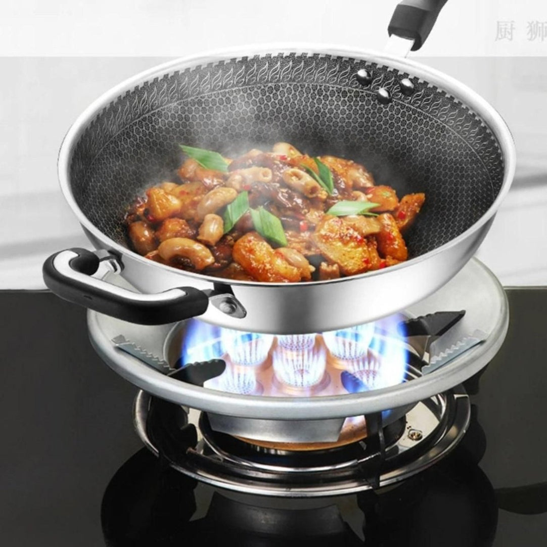 Stir-fry dish in a wok on a gas stove with visible flames