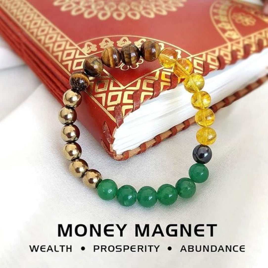 Colorful beaded bracelet on a red book with 'Money Magnet' text