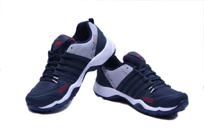 Pair of navy blue athletic shoes with white soles on a white background