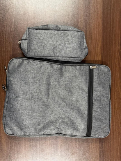 Two gray zippered pouches on a wooden surface