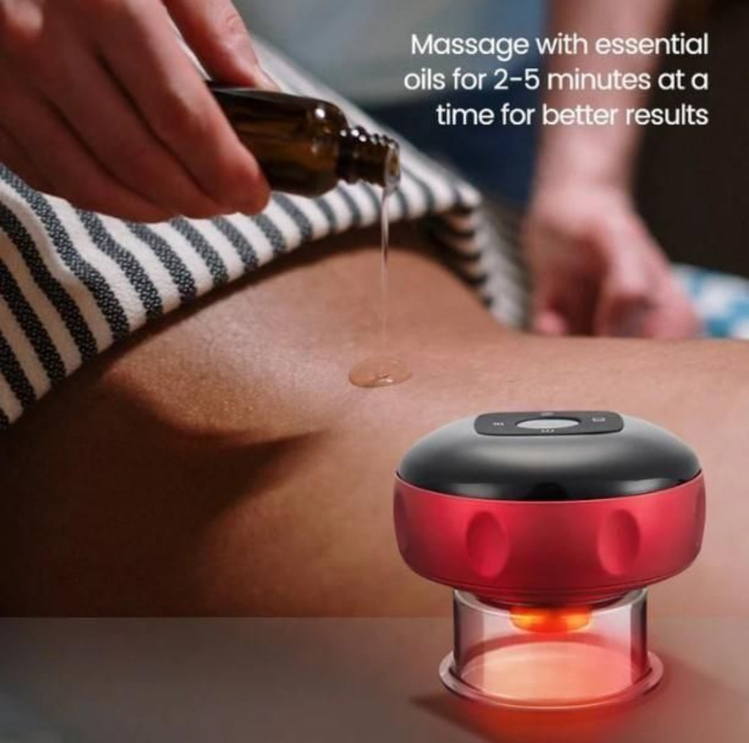 Red and black handheld massager on a person's leg with essential oil being applied.