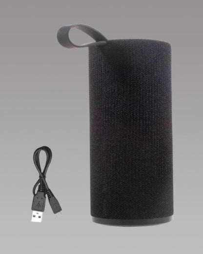A black portable wireless Bluetooth speaker with a textured surface, a handle on top, and a USB charging cable.