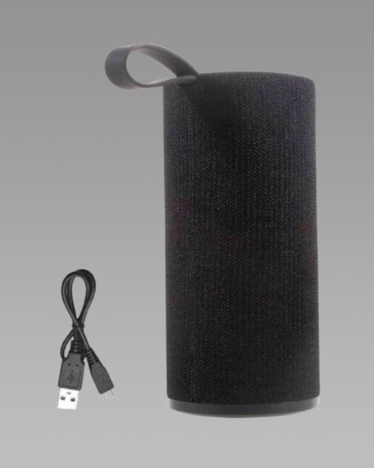 A black portable wireless Bluetooth speaker with a textured surface, a handle on top, and a USB charging cable.