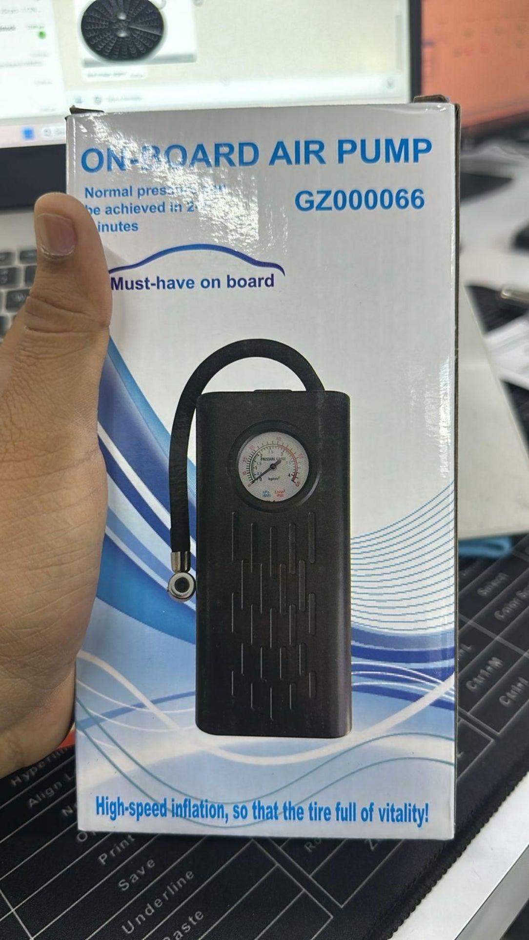 Onboard air pump with packaging on a blurred background