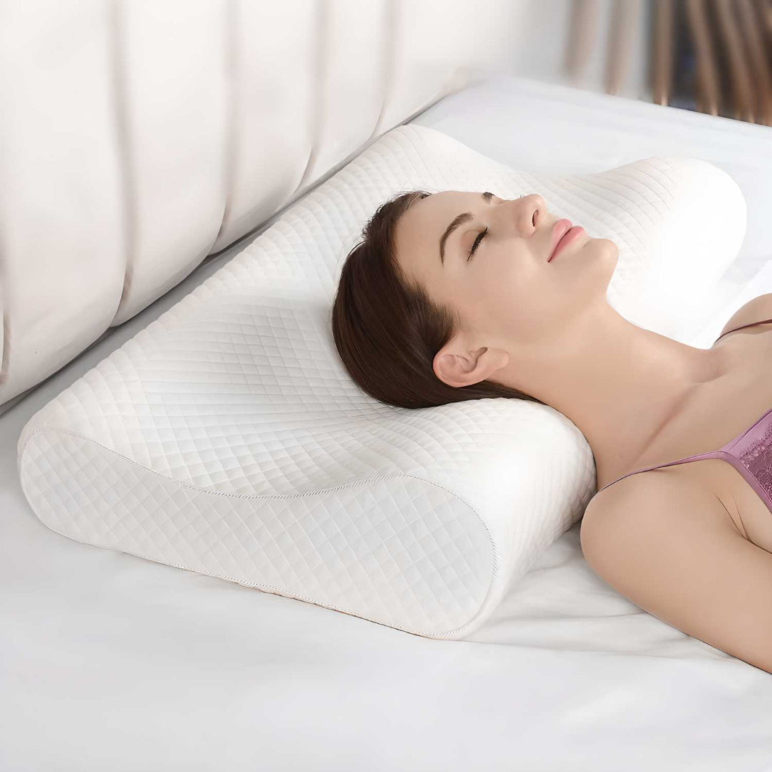 Woman lying on a white bed with a white pillow, wearing a purple bra.