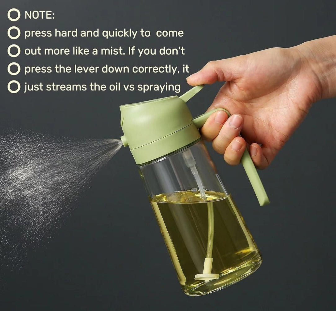 Hand holding a green oil sprayer with instructions on a dark background