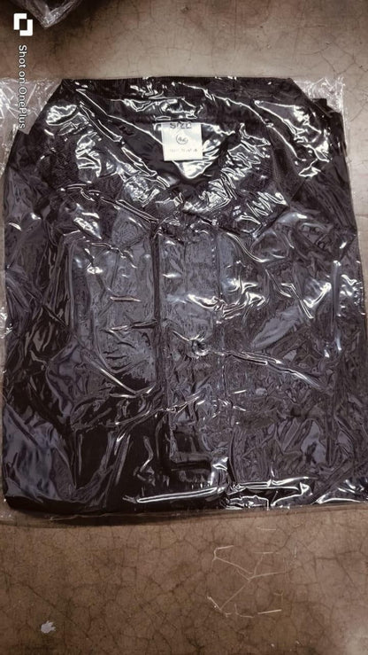 Black jacket in clear plastic wrap on a brown surface