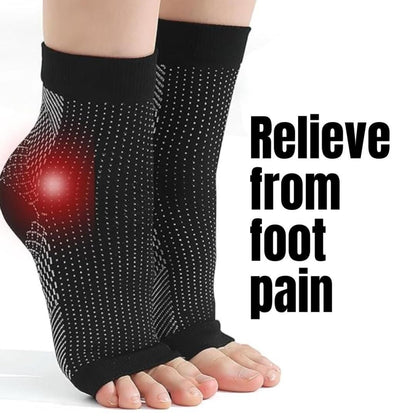 A pair of black neuropathy socks designed to relieve swelling in the feet and ankles, with a visible red area indicating foot pain.
