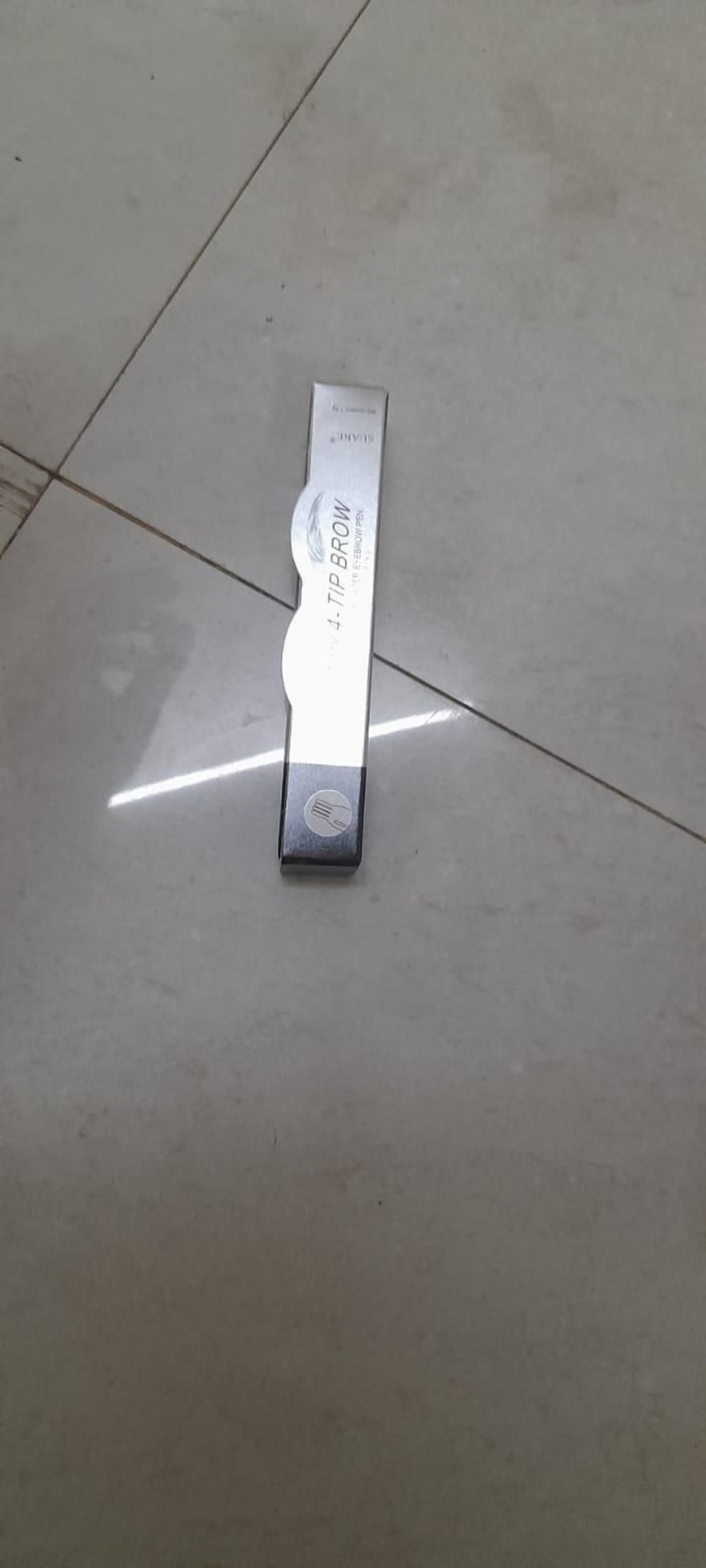 Metal ruler on a tiled floor