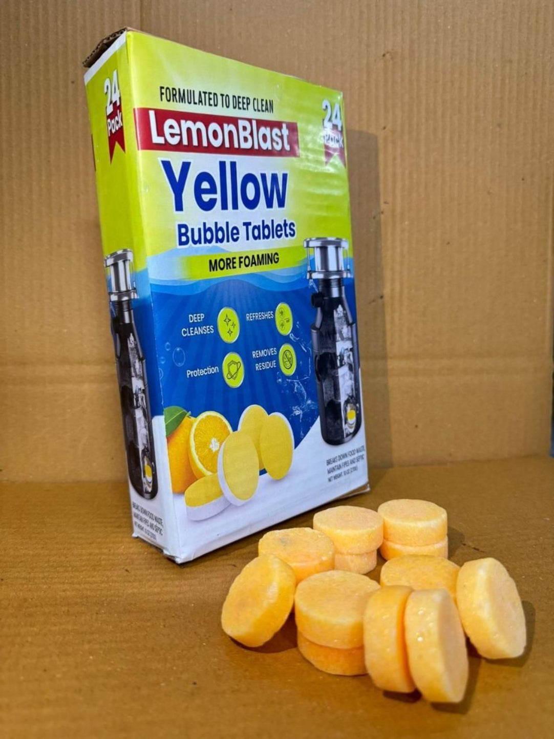 Box of Lemon Blast Yellow Bubble Tablets with tablets on a cardboard background