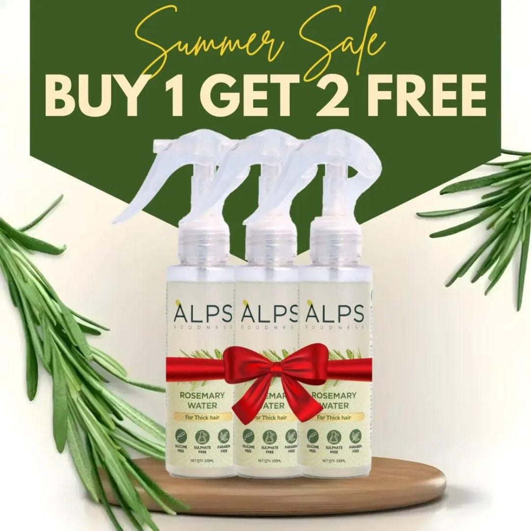 Three bottles of ALPS brand Rosemary Water Hair Spray arranged on a wooden surface with a decorative bow and rosemary leaves in the background, promoting a buy 1 get 2 free offer.