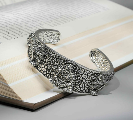 Decorative silver bracelet on an open book