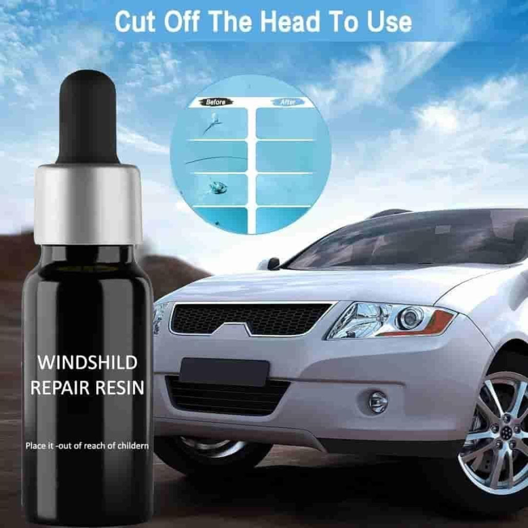 Bottle of windshield repair resin with car in the background