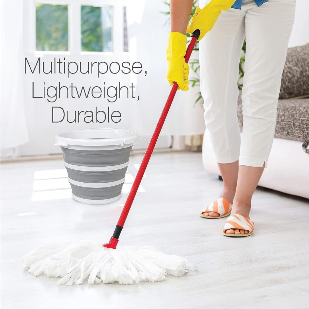 Person cleaning a floor with a red mop, wearing yellow gloves, in a home setting.