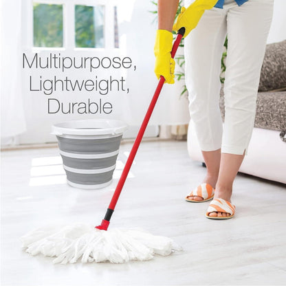 Person cleaning a floor with a red mop, wearing yellow gloves, in a home setting.