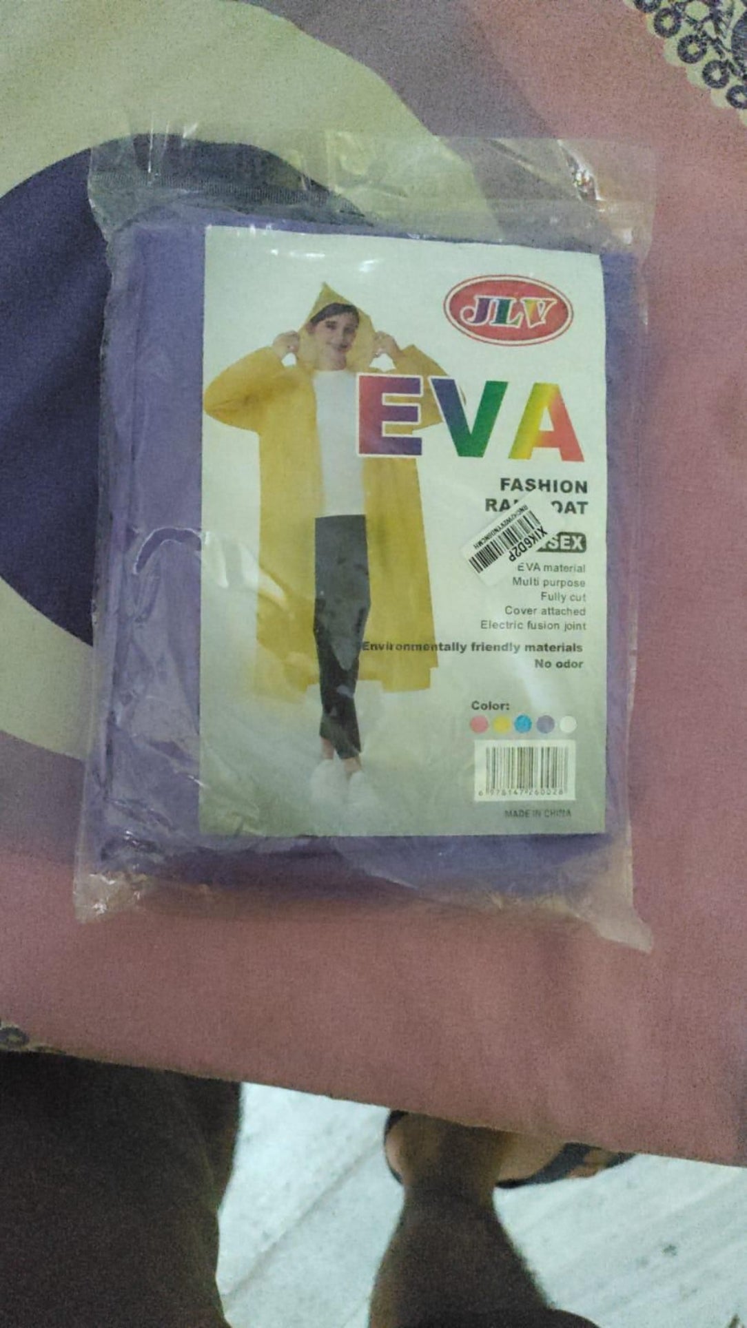 Packaged EVA fashion product with a colorful label on a pink background