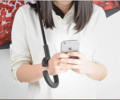 Person using a smartphone with an umbrella-like stand