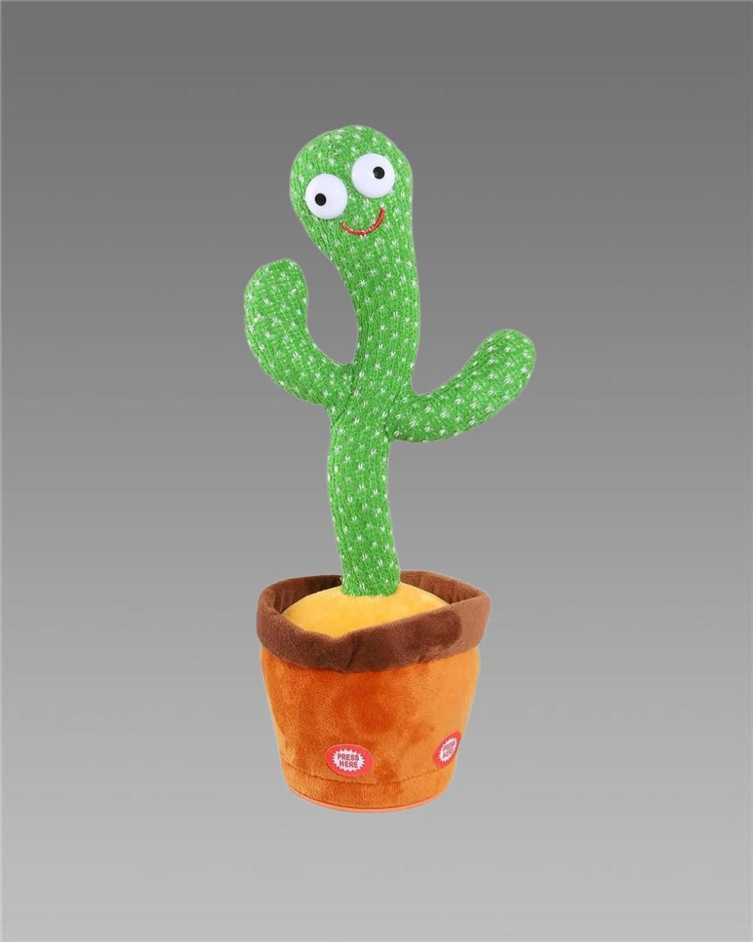 A plush cactus toy with a green body, placed in an orange pot, featuring eyes, a mouth, and a movable arm, set against a grey background.