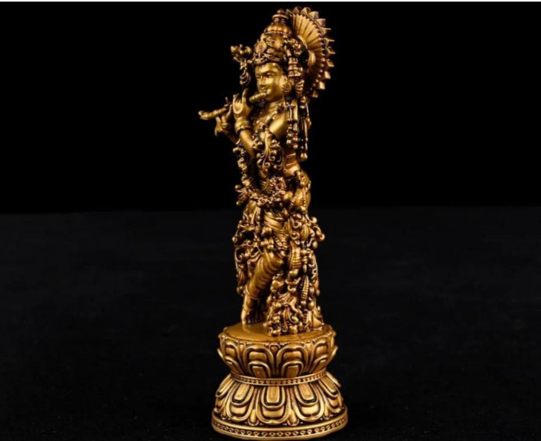 Gold-colored statue on a black background