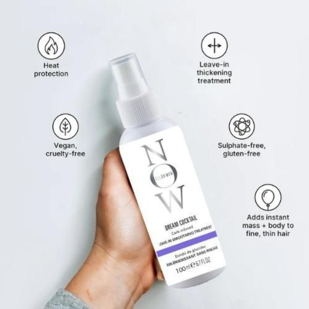 Hand holding a hair treatment bottle with text highlighting features on a white background