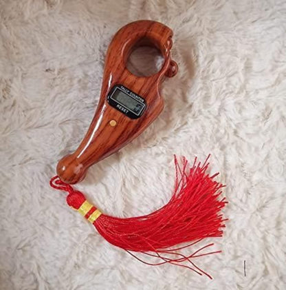 Wooden weight scale with digital display and red tassel on a textured white surface