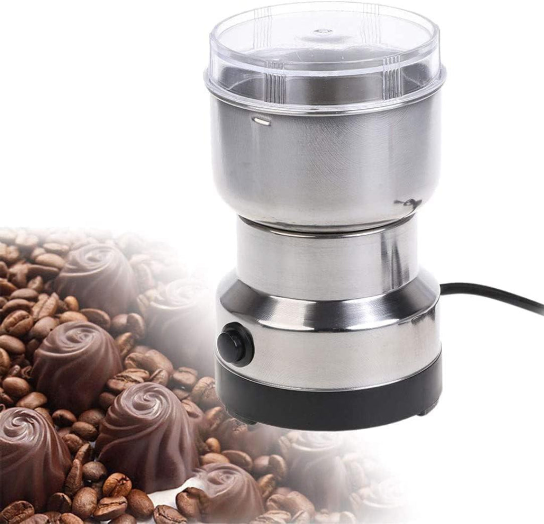 Coffee grinder with coffee beans and chocolate truffles on a white background