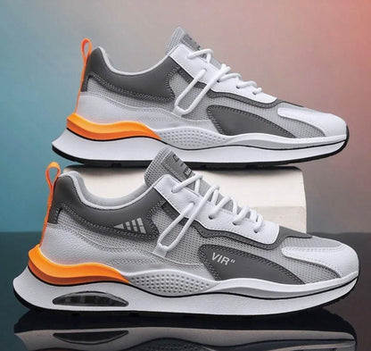 A pair of men's casual shoes with white synthetic material and Airmix sole, featuring gray and orange accents, lace-up closure and modern design.