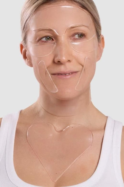 Woman wearing clear face masks on a plain background