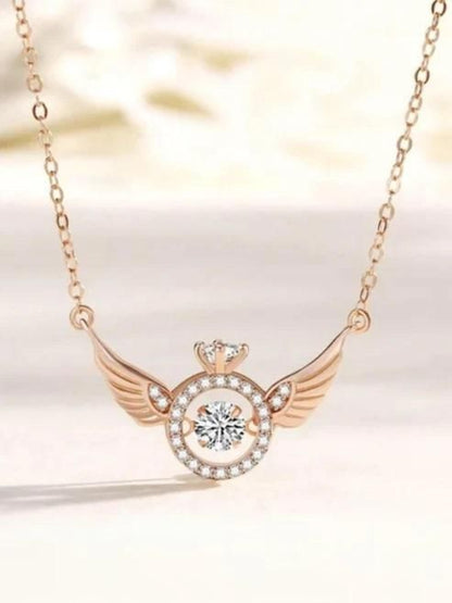 Necklace with a heart and wings design on a soft background
