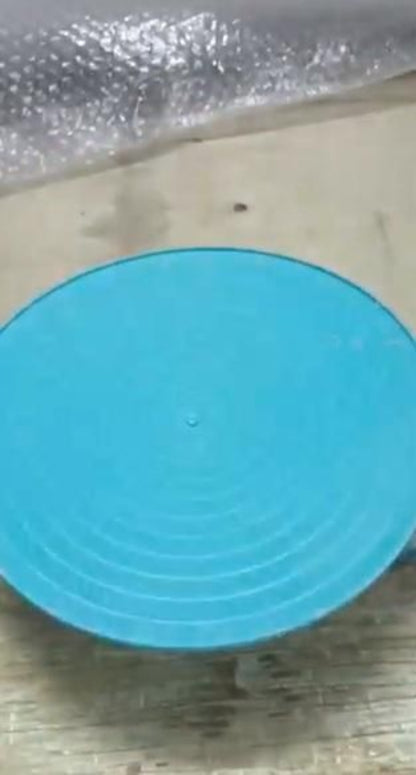 Blue circular object on a textured surface with bubble wrap in the background