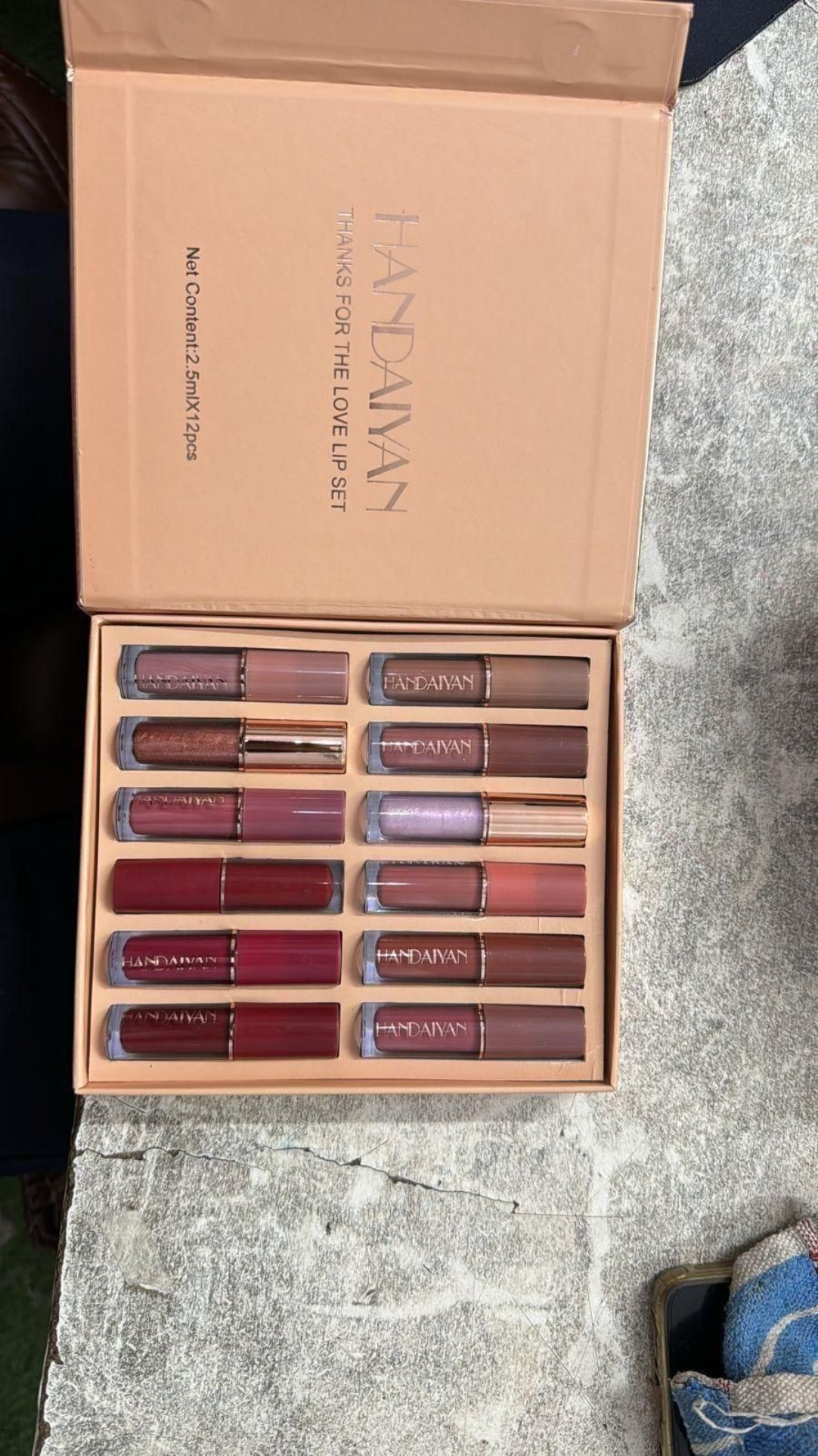 Set of lipsticks in a 'Fantasy' box on a textured surface
