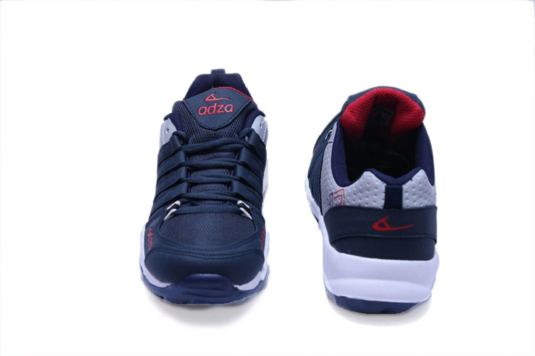 Navy and white sneakers with red accents on a white background