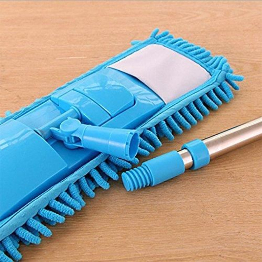 Blue cleaning brush with bristle head on a wooden surface