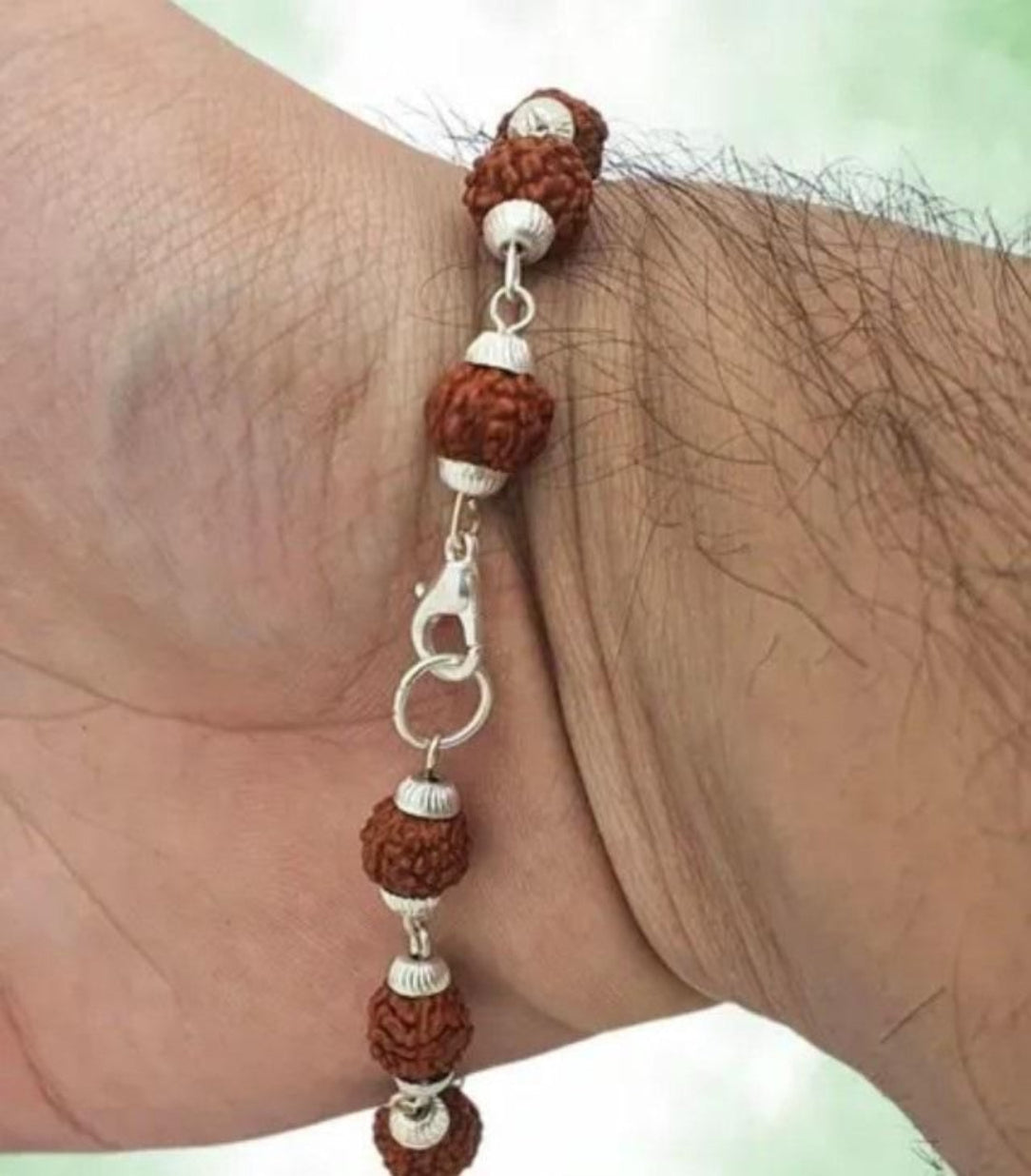 Bracelet with brown and silver beads on a wrist
