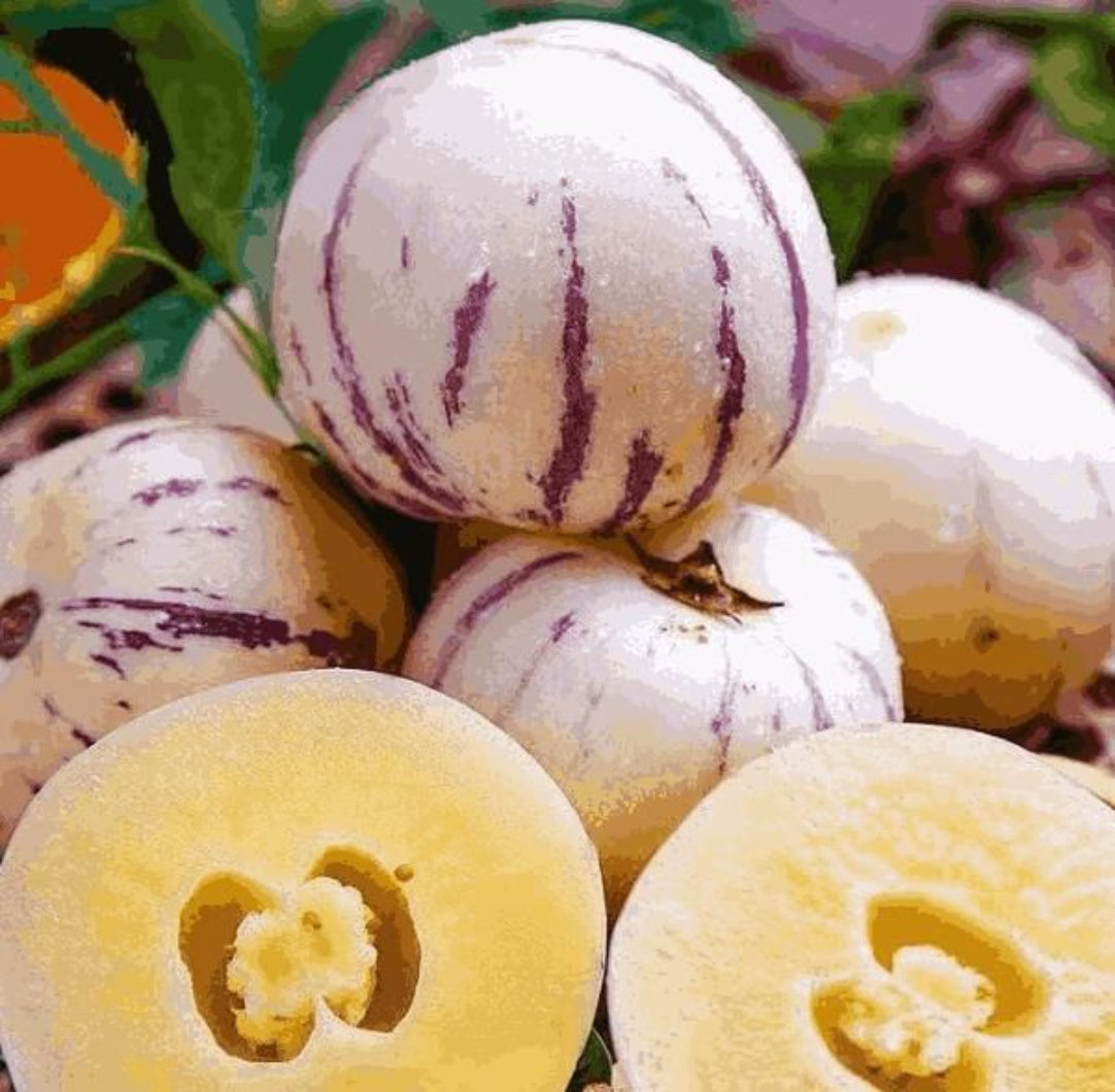 Close-up of white and purple striped fruits with a halved fruit showing a central core.