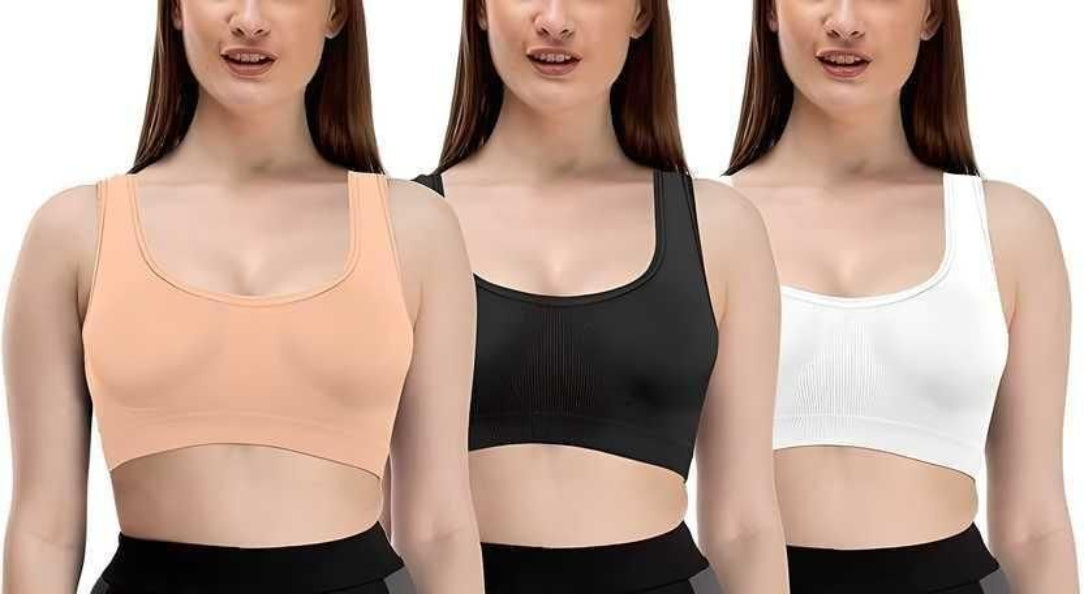 Three women wearing different colored sports bras on a white background